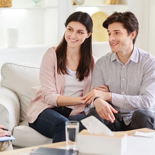 About Us counselor and happy couple after effective marital